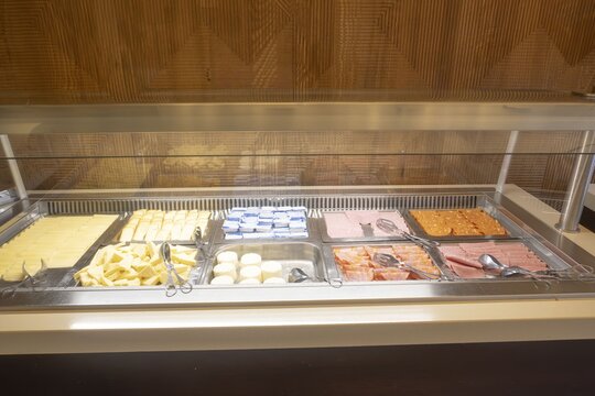 Hotel breakfast buffet offering various cheeses and cold cuts