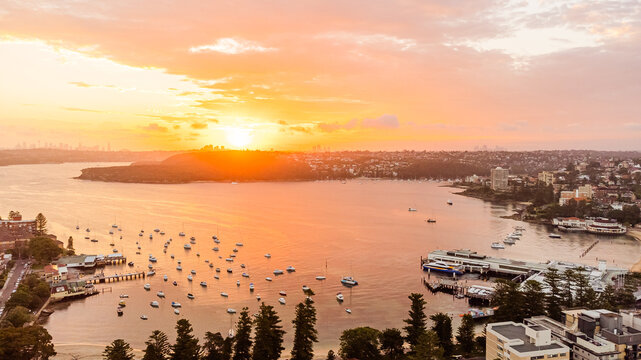 wide view of bay with boats at golden hour sunset