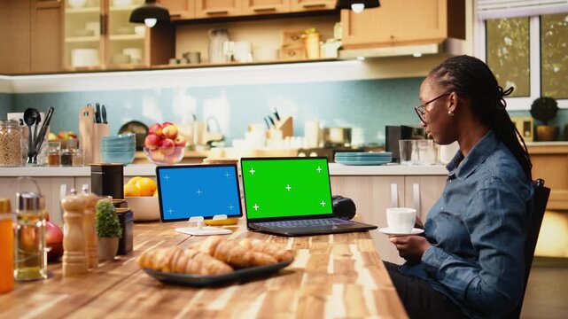 Green screen laptop and blue screen tablet with young woman