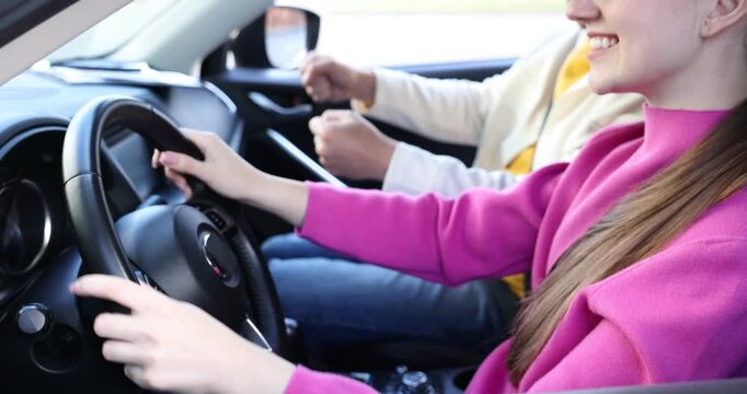 Woman having driving lesson with instructor in car, closeup