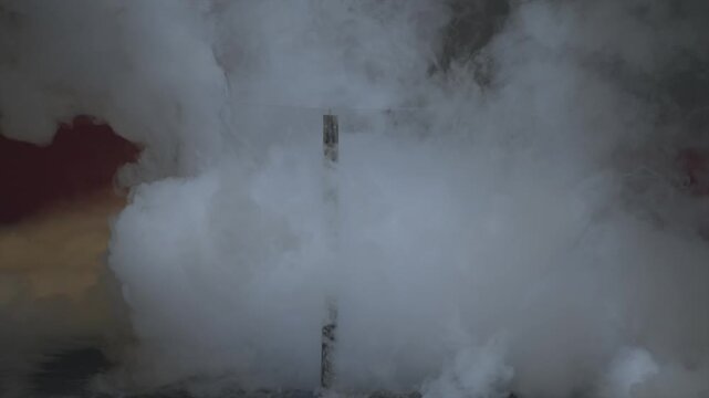 Dramatic close-up: A scientist behind a protective shield throws liquid nitrogen into a bucket, triggering an instant explosion of dense white vapor and cryo-smoke under moody lab lighting.