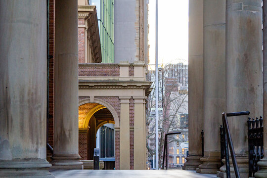 Tall stone columns leading toward a red‑brick building in sydney