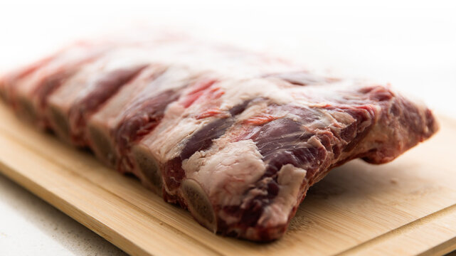 raw beef ribs on a chopping board ready to cook