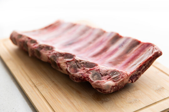 beef ribs on a bamboo chopping board