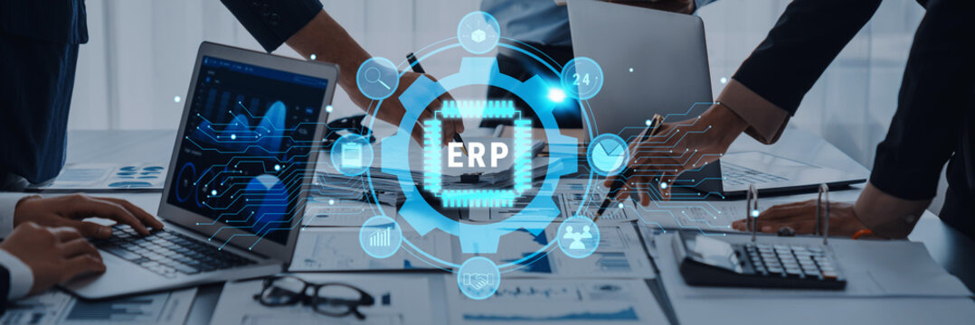 Business professionals engage in collaboration on an ERP system implementation, analyzing data and discussing strategies in a modern office environment. Trope