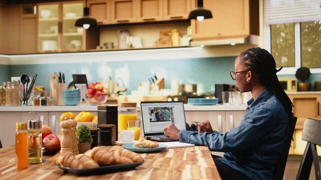 Adult woman browses video-sharing website on laptop, playing recorded content for online entertainment while viewing user-generated free-to-watch video as part of casual digital lifestyle and leisure.