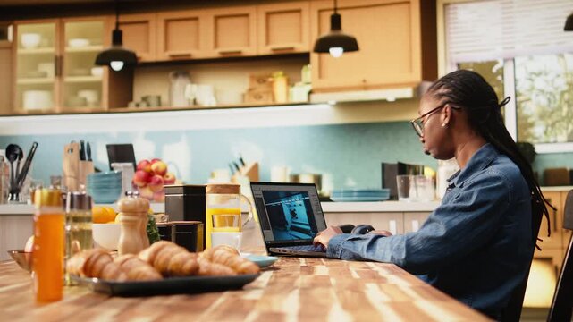 Woman game developer building video game with 3D modeling on laptop