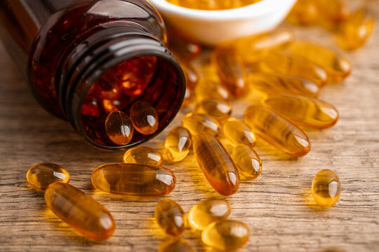 Fish oil or Cod liver oil gel in capsules with omega 3 vitamins, supplementary healthy food.