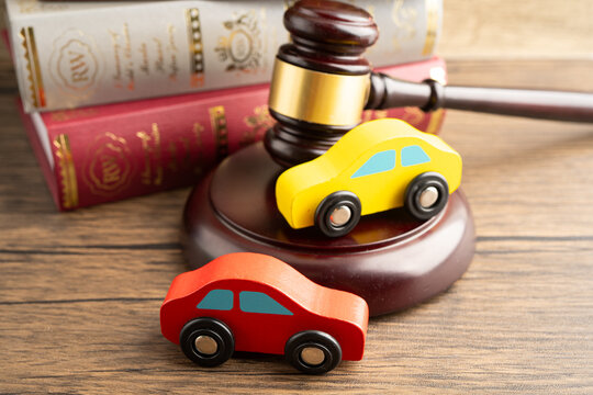 Hammer gavel judge with car vehicle accident, insurance coverage claim lawsuit court case.