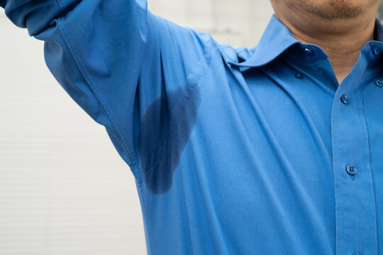 Man with sweaty arm pit on shirt when working in office, Hyperhidrosis sweating.