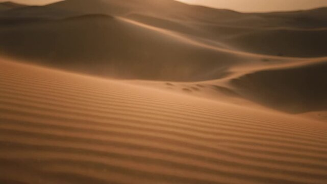 Sweeping curve of a desert sand dune with wind blowing dust over the rippled crest