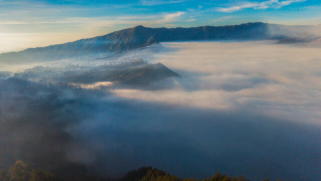Bromo volcano mountain at sunrise in East Java, Indonesia surrounded by morning fog