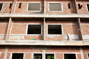 Obraz premium exterior view of brick house under construction with concrete structure