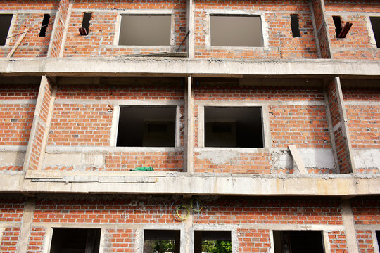 exterior view of brick house under construction with concrete structure