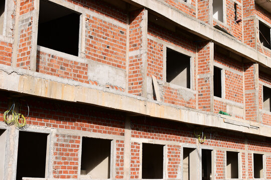exterior view of brick house under construction with concrete structure