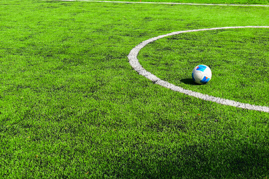 football on green grass pitch with white boundary line marking