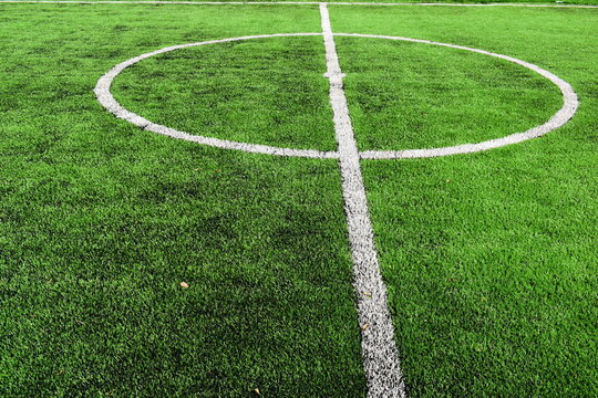 green synthetic grass field texture with white boundary line for sport background