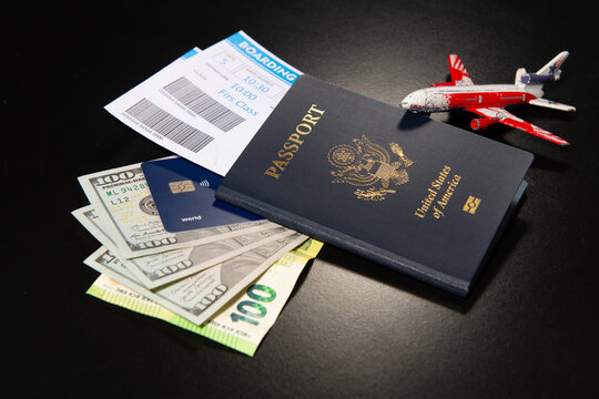 US passport with boarding pass credit card and toy airplane. International travel concept with American passport. Travel air flight concept. Travel budget. Airport trip preparation. Aviation travel.