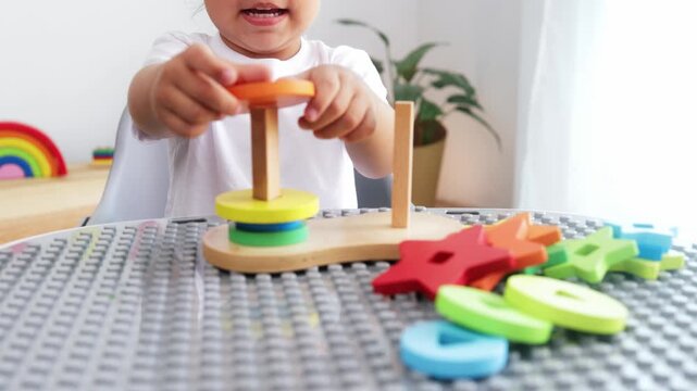 Kid playing with wood toys at pre school classroom - Kindergarten education, cognitive development and Montessori smart games concept