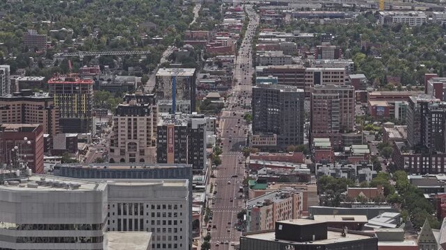 Aerial view showing a busy street, buildings, and green trees in a city urban landscape denver colorado 4K