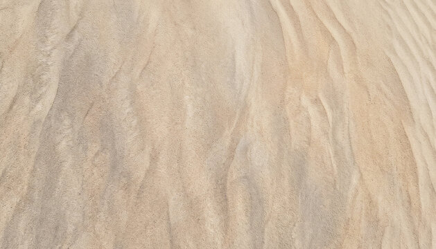 Close-up view of smooth, textured sand surface with subtle patterns and shades of beige, creating a natural and serene background.