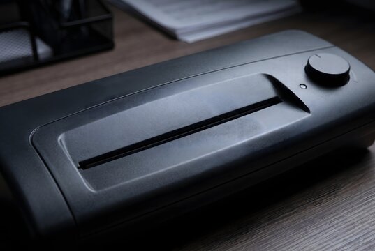 Close up of the pouch entry slot and plastic top housing of a desktop document laminator