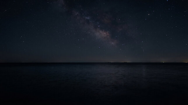 Stunning dark night sky filled with stars over a calm ocean perfect for peaceful cosmic backgrounds and ethereal astrology design concepts