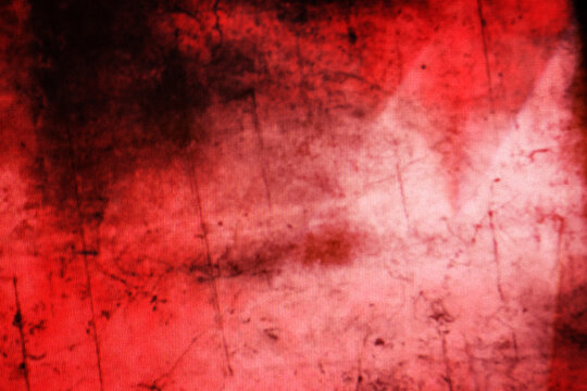 A dark grunge background with vintage red and orange striped paint texture on an old aged wall