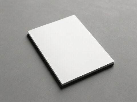 A stacked ream of blank white paper rests upon a flat dark surface creating professional visual appeal for promotional flyers and marketing materials requiring custom graphic designs