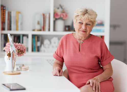 Smiling senior woman enjoying beauty and self care routine at home