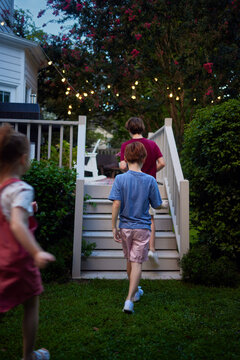 Rear view of children heading home after playing outside on a cozy summer evening