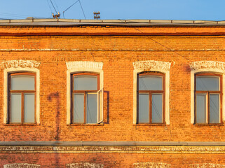 Four windows of the old mansion 19 century with brown bricks wall © Dmitrii Potashkin