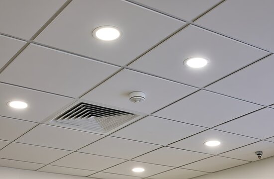 White acoustic ceiling with recessed lights, vent, and smoke detector