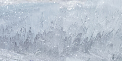 Closeup of sharp translucent ice crystals as natural frozen texture in cold winter banner. Abstract...