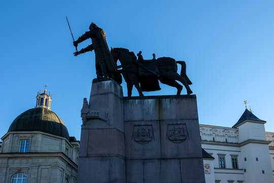 Vilnius, Lithuania &ndash; Silhouette of the bronze Monument to Grand Duke Gediminas. The domed chapel of Vilnius Cathedral and the Palace of the Grand Dukes provide a historic architectural background.