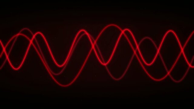 Abstract glowing red wave lines moving smoothly across a dark black background for technology concepts