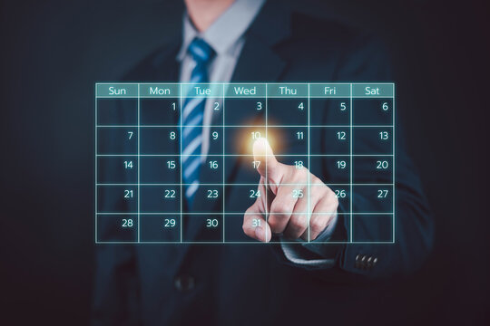 Businessman touching a glowing digital calendar, symbolizing scheduling, time management, appointment planning, business organization, productivity, workflow, meetings, deadlines