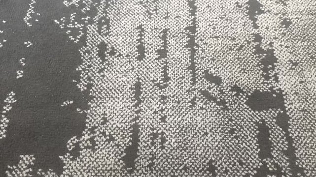 Top down angle view of dark grey abstract patterned carpet texture
