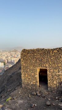Scenic hilltop view of Medina cityscape and Masjid Al Fath from historic stone ruins.