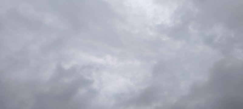 Layered gray clouds drifting across the daytime sky timelapse