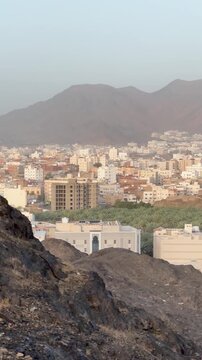Panoramic view of Medina cityscape, surrounding mountains, and Masjid Al Fath minaret.