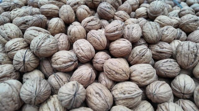 Gathering and processing walnuts during harvest time in a local market