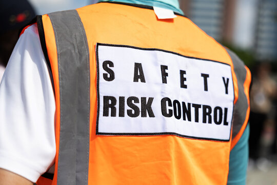 Orange safety vest with Safety Risk Control label