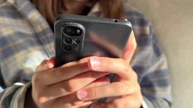 Teenage girl hands holding smartphone close up, digital technology, mobile device