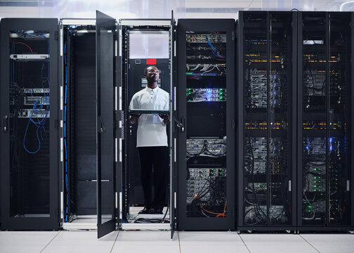 IT Technician Installing Server Equipment in Data Center