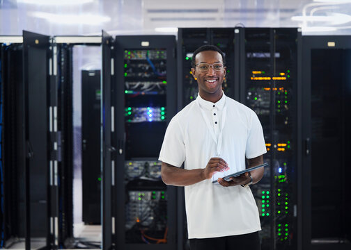 Black IT Technician Using Tablet in Data Center Server Room