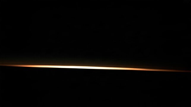 imminent. The dark horizon before dawn, a faint sliver of pale light emerging, signaling the imminent sunrise. travel magazines, destination branding, designed for travel destination branding.
