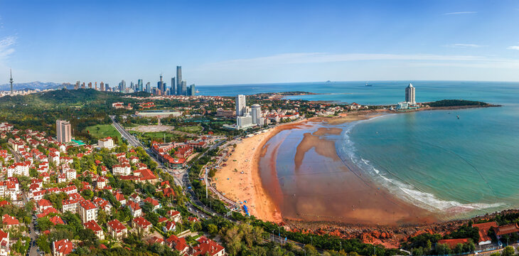 Aerial Panorama of Coastal City Beach Under Clear Blue Sky