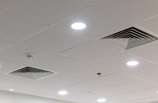 White grid ceiling with recessed lights, vents, and sprinkler heads