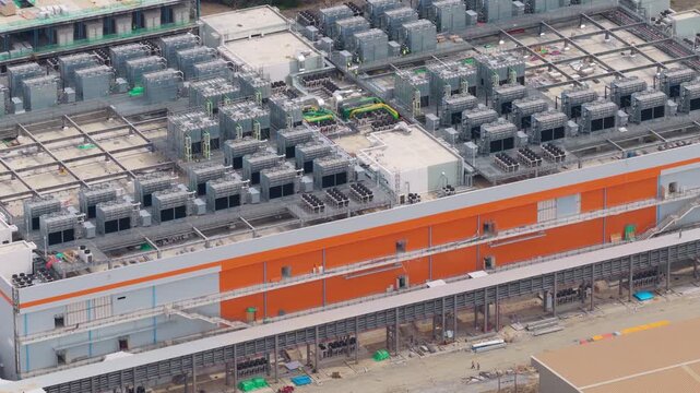 Aerial view of a large scale data center construction site, showcasing the massive cooling systems and infrastructure for future cloud computing